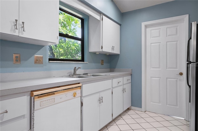 kitchen featuring white cabinets, dishwasher, stainless steel fridge, and sink