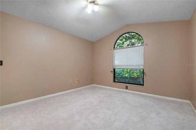 unfurnished room with a textured ceiling, lofted ceiling, ceiling fan, and light carpet