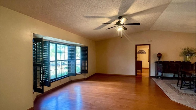 living room with ceiling fan, lofted ceiling, and wood-type flooring