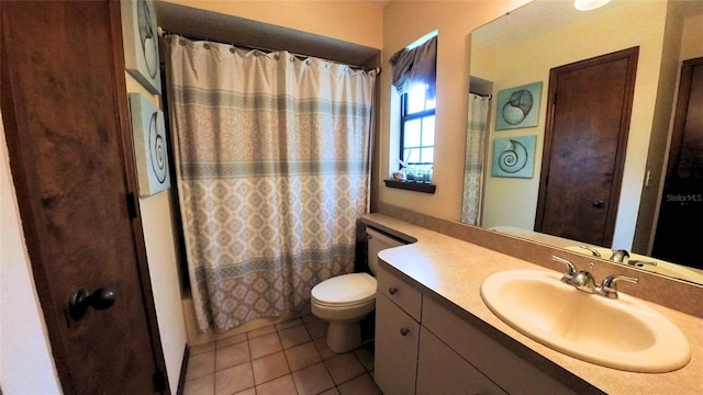 bathroom with tile patterned flooring, vanity, toilet, and walk in shower