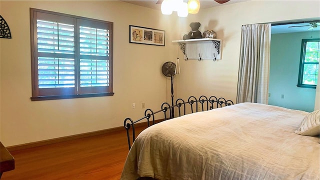 bedroom with hardwood / wood-style floors and ceiling fan