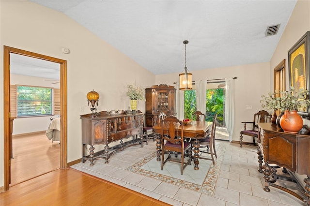 dining space featuring lofted ceiling, a healthy amount of sunlight, and visible vents