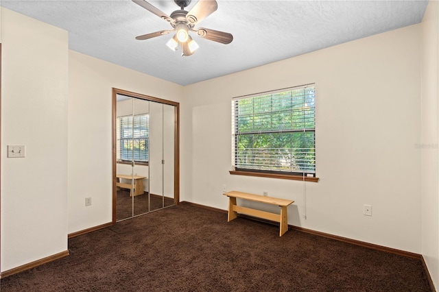 unfurnished bedroom featuring a closet, baseboards, carpet floors, and a textured ceiling