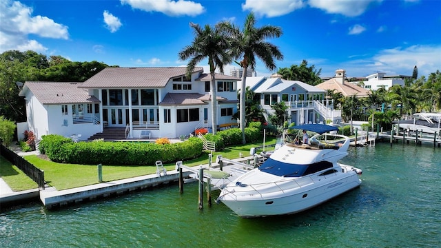 view of dock featuring a water view and a lawn