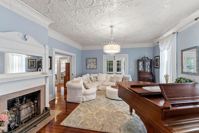 living room featuring a fireplace, dark wood-style floors, an ornate ceiling, and ornamental molding