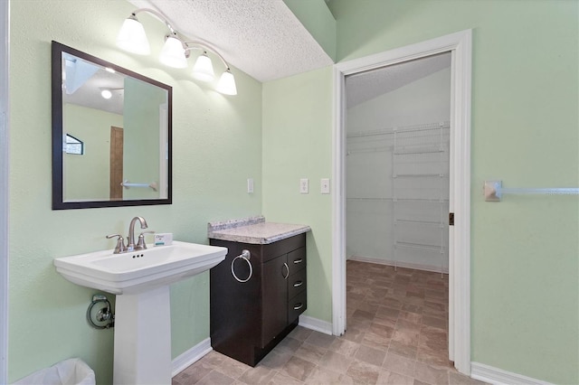 bathroom with a textured ceiling and sink