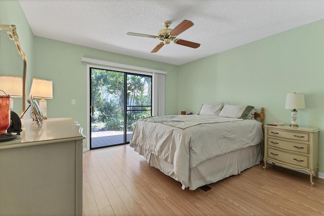 bedroom with light hardwood / wood-style flooring, ceiling fan, access to outside, and a textured ceiling