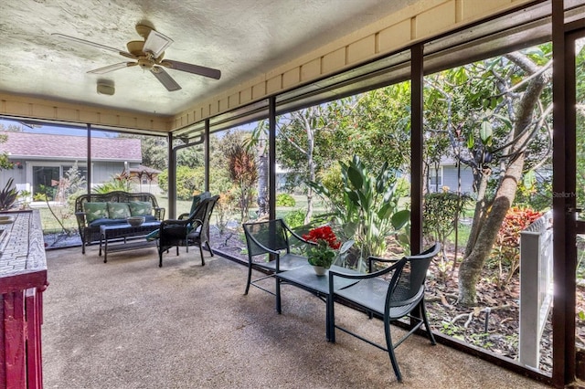 unfurnished sunroom featuring ceiling fan