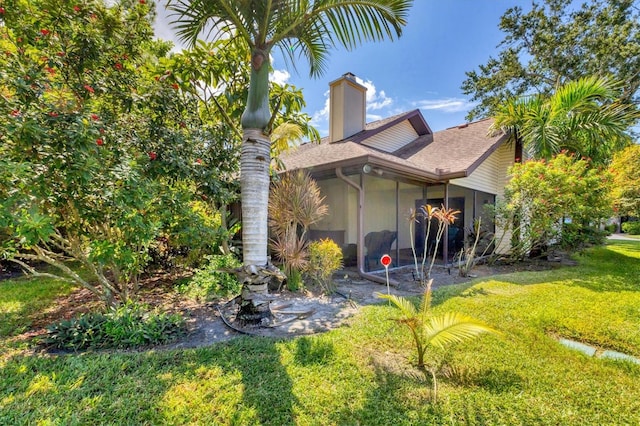 view of side of home featuring a lawn