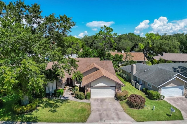 view of front of property with a garage and a front lawn