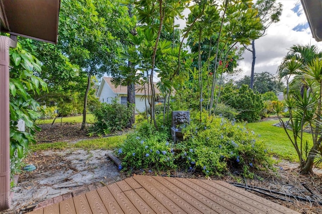 wooden terrace featuring a lawn