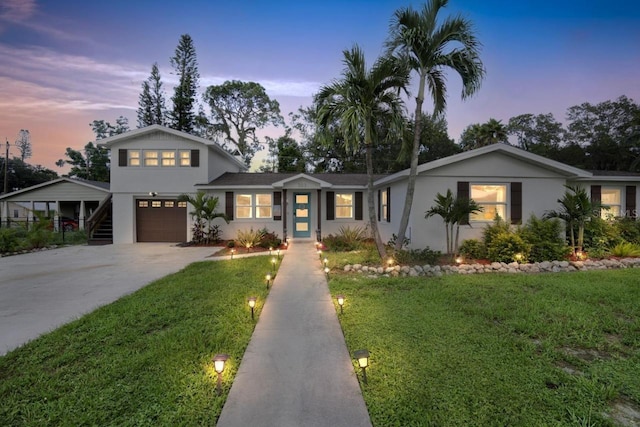 view of front of property with a lawn and a carport