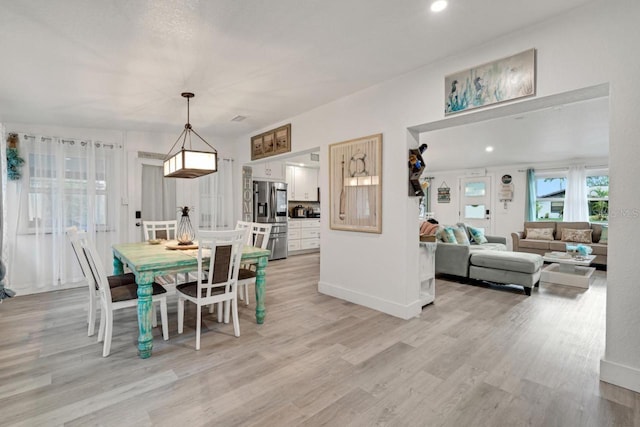 dining room featuring light wood-style flooring, baseboards, and recessed lighting