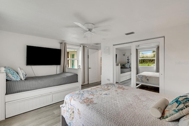 bedroom with visible vents, ceiling fan, and wood finished floors