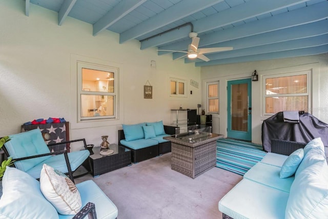 carpeted living room featuring lofted ceiling with beams, ceiling fan, and wood ceiling