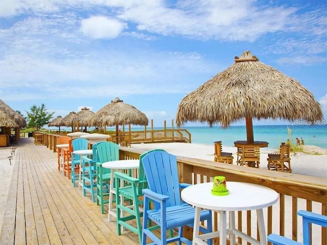 wooden terrace with a water view and a gazebo