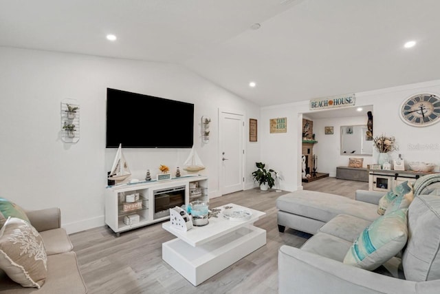 living area featuring baseboards, lofted ceiling, light wood-style floors, and recessed lighting