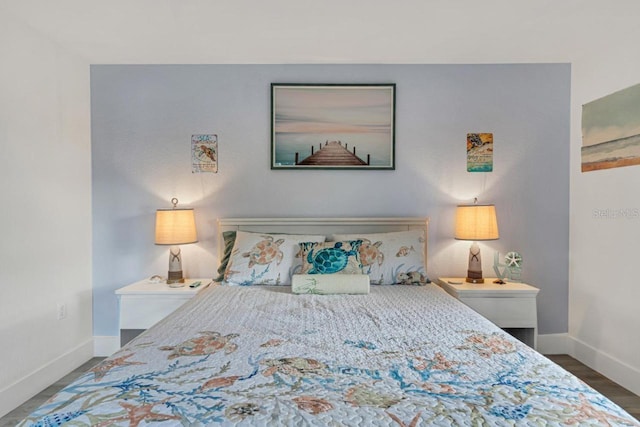 bedroom featuring baseboards and wood finished floors