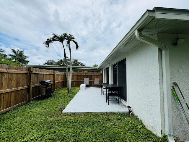 view of yard with a fenced backyard and a patio