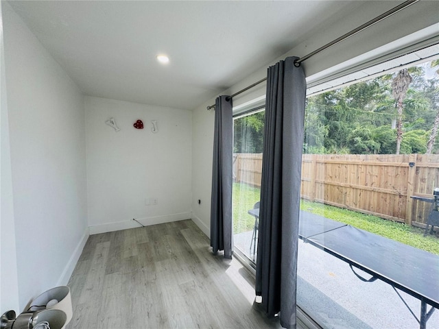 unfurnished room with baseboards and wood finished floors