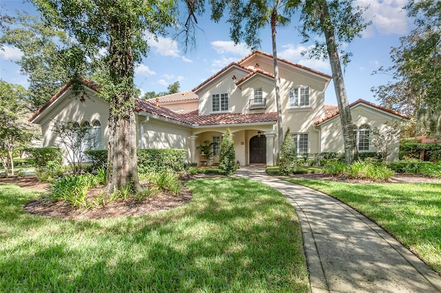 mediterranean / spanish-style house with a front lawn