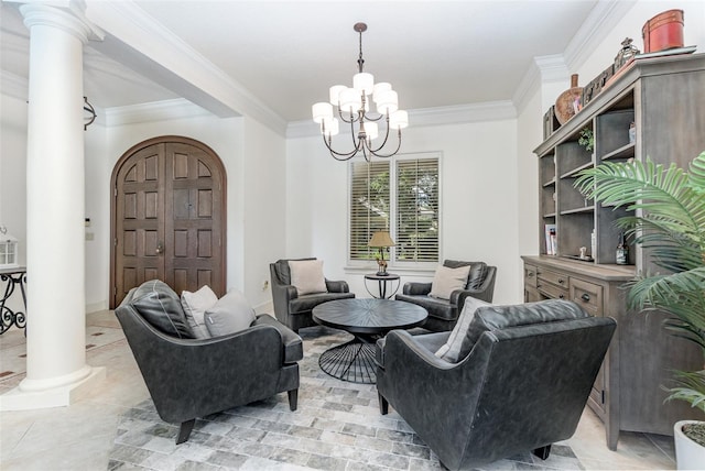 living area featuring ornamental molding, a chandelier, and ornate columns