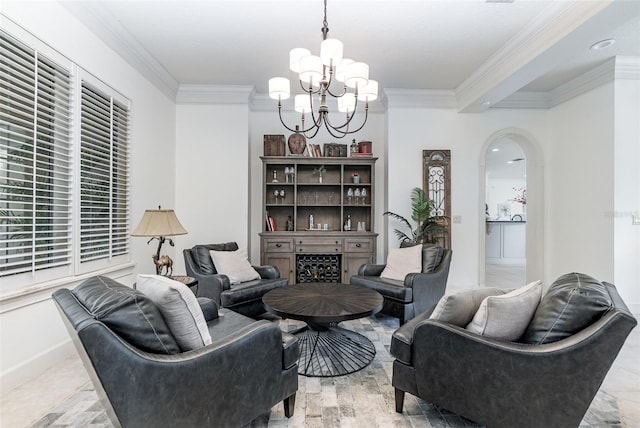 living room featuring an inviting chandelier, a fireplace, and crown molding