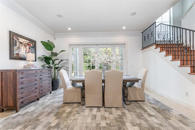 dining area featuring light hardwood / wood-style floors and ornamental molding