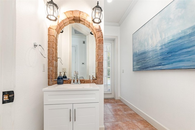 bathroom with tile patterned floors, vanity, and crown molding