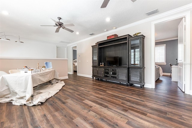 bedroom featuring ceiling fan, ornamental molding, a textured ceiling, and dark wood-type flooring