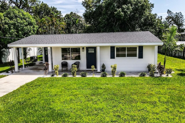 single story home featuring a carport, a porch, and a front lawn