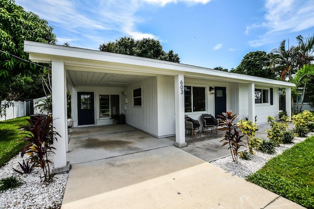 view of front of property featuring a porch and a carport