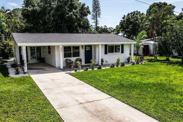 ranch-style home with a front yard and a carport