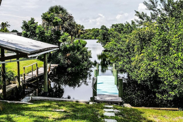 dock area with a yard and a water view