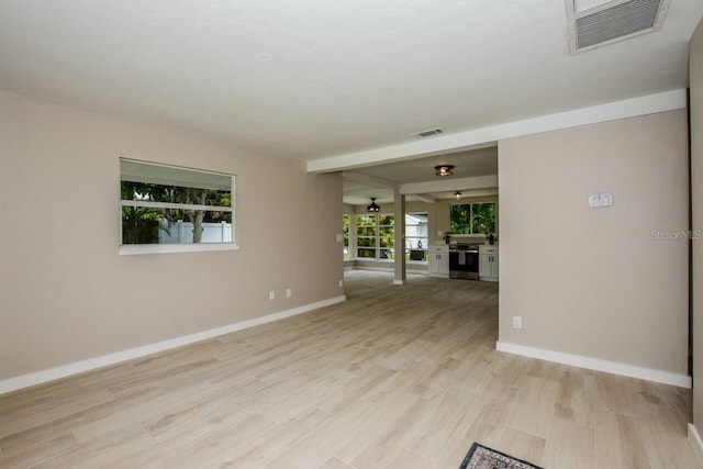 unfurnished room with light wood-type flooring