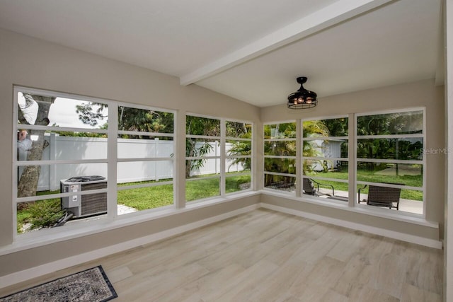 unfurnished sunroom with vaulted ceiling with beams