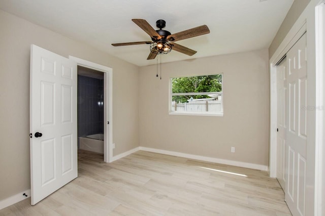 unfurnished bedroom with light wood-type flooring, a closet, and ceiling fan