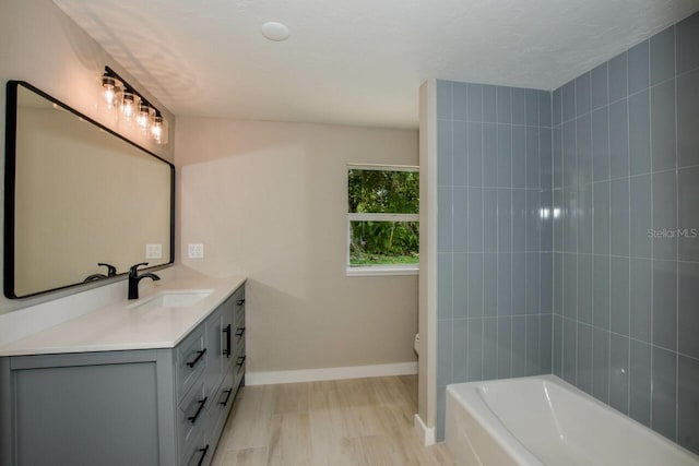 bathroom with hardwood / wood-style floors, vanity, and toilet