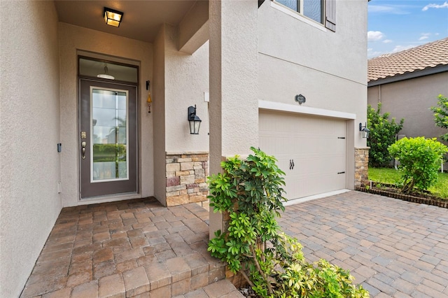 view of exterior entry featuring a garage