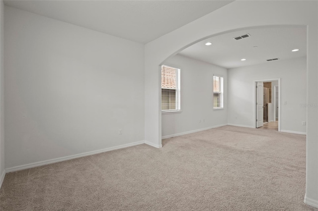 unfurnished room with light colored carpet