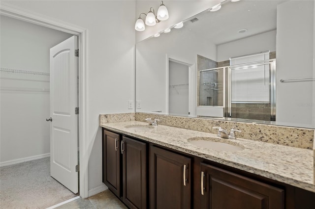 bathroom featuring walk in shower and vanity