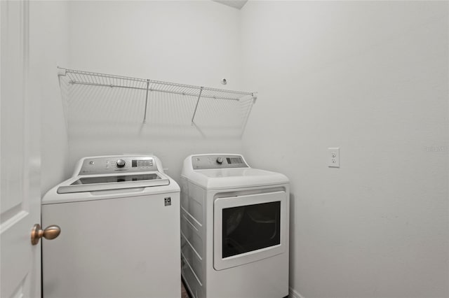 washroom featuring washing machine and dryer