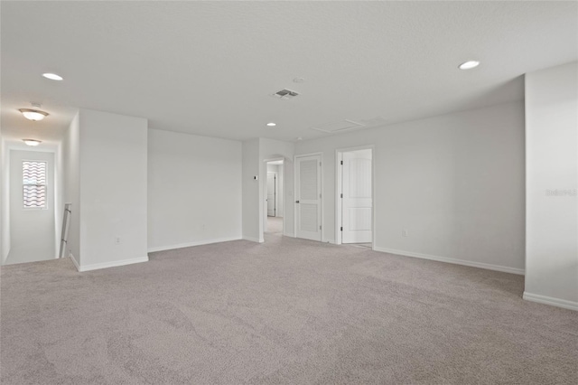 unfurnished room with light colored carpet