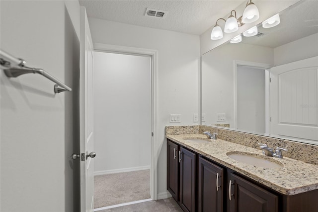 bathroom featuring vanity and a textured ceiling