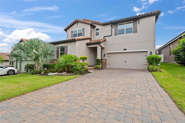 mediterranean / spanish house featuring a front lawn and a garage