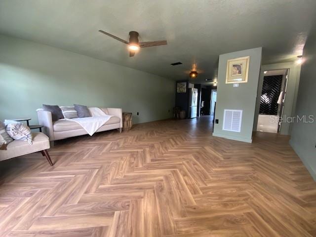 interior space with parquet floors and ceiling fan