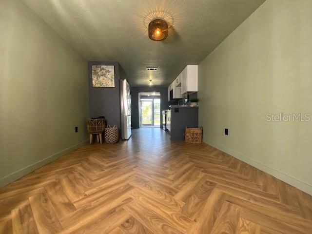 unfurnished living room with light parquet floors