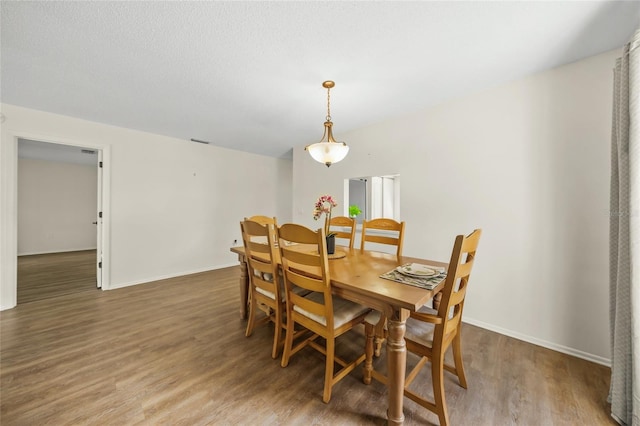 dining area with hardwood / wood-style floors