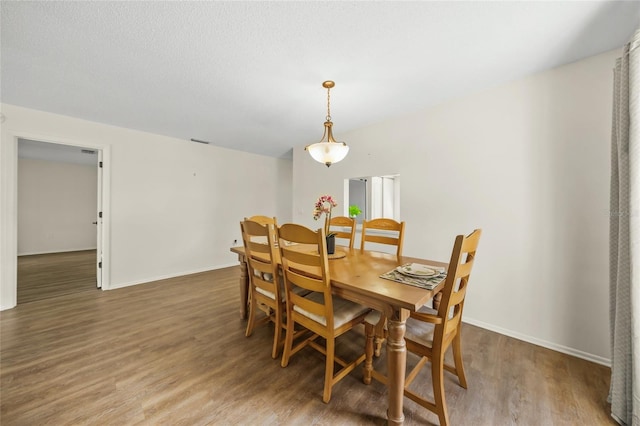 3653 Bonaventure Ct, Sarasota, FL 34243 - dining area with wood finished floors and baseboards