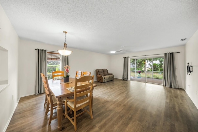 dining space with a textured ceiling, dark hardwood / wood-style floors, and ceiling fan